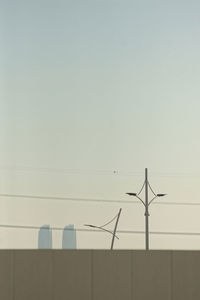 Low angle view of wind turbine against clear sky