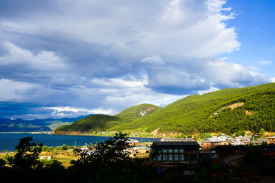 Scenic view of building and mountains against sky