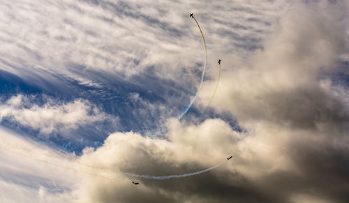 Low angle view of vapor trails against sky