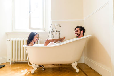 Woman sitting in bathroom