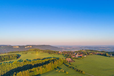 Scenic view of agricultural field against clear blue sky