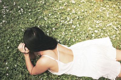 High angle view of woman relaxing on field