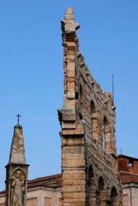 Low angle view of old building against clear blue sky