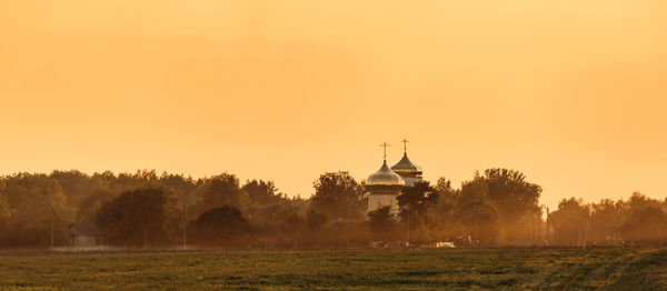 Scenic view of field against sky during sunset