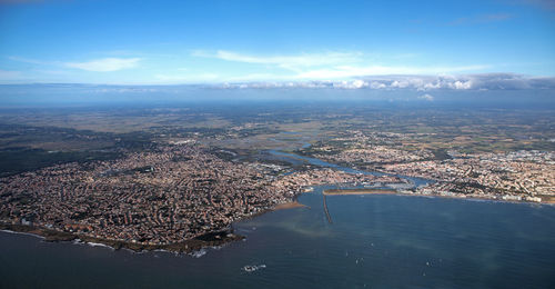 Aerial view of city and sea against sky