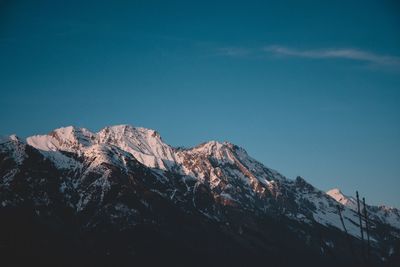 Scenic view of snowcapped mountains against clear blue sky