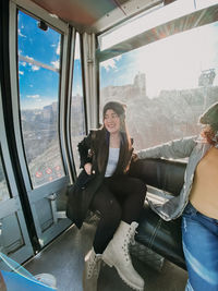 Women sitting by window in overhead cable car