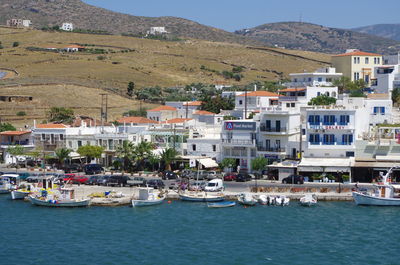 Boats moored in city by sea