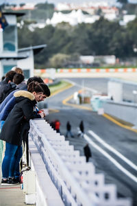 People standing by railing