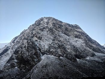 Low angle view of mountain range against clear sky