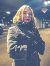 Portrait of mature woman standing outdoors in winter