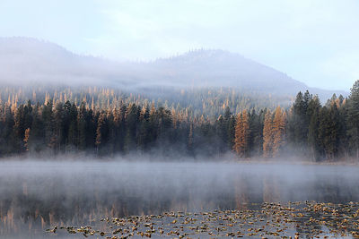 Panoramic view of lake against sky during foggy weather