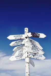 Low angle view of information sign against sky