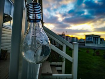 Close-up of light bulb against sky