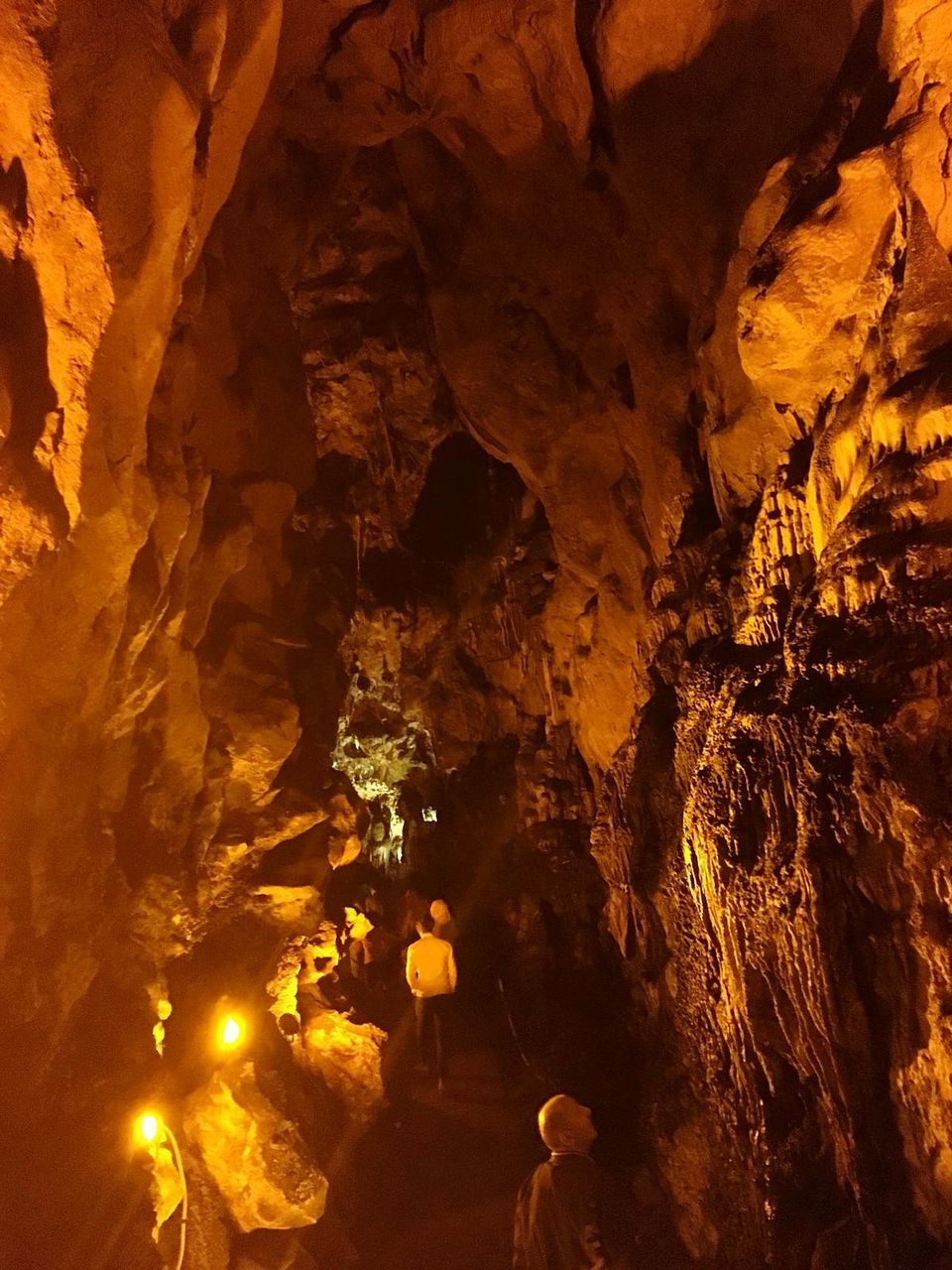 rock formation, cave, solid, rock, rock - object, geology, physical geography, nature, no people, illuminated, outdoors, beauty in nature, travel destinations, stalactite, fire, rough, fire - natural phenomenon, eroded