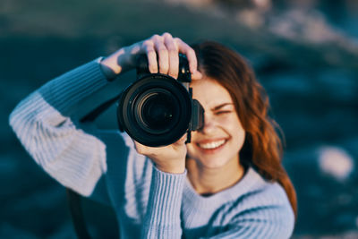 Portrait of woman photographing