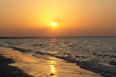 Scenic view of sea against orange sky