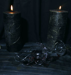 Close-up of illuminated candles on table