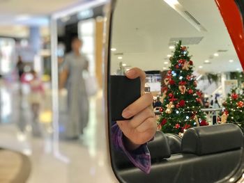 Man using smart phone in christmas tree