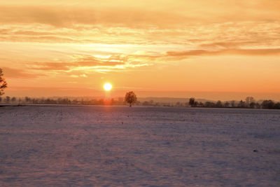 Scenic view of snow covered landscape during sunset