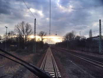 Railroad track against cloudy sky