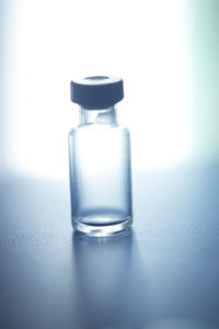 Close-up of water bottle on table against blue background