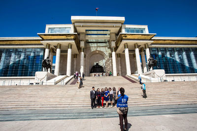Group of people in front of historical building