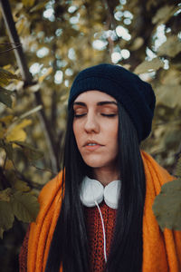 Brunette woman portrait with her headphones in the forest