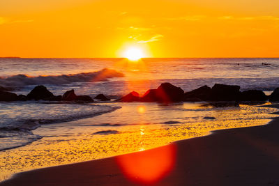 Scenic view of sea against romantic sky at sunset