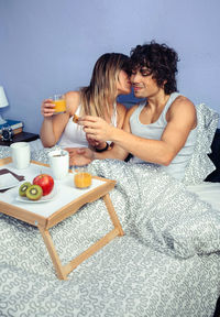 Young couple sitting on table at home