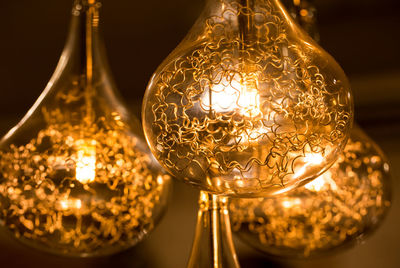 Close-up of illuminated electric bulbs in darkroom