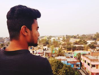 Portrait of young man looking at cityscape