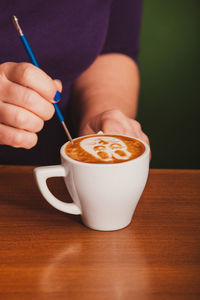 Close-up of hand holding coffee cup