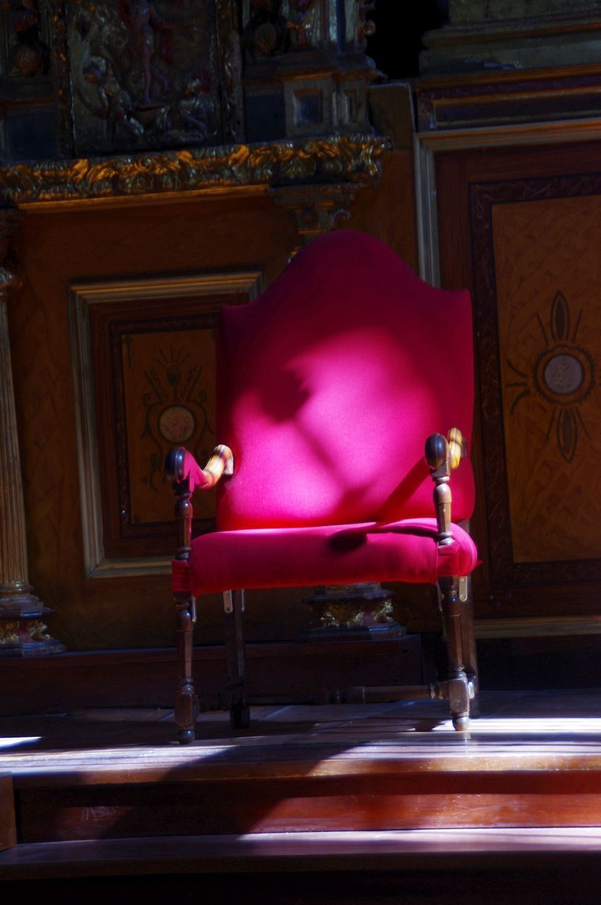 SIDE VIEW OF MAN SITTING BY CHAIR