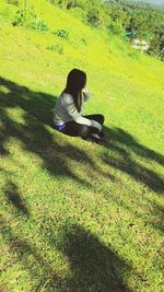 Man sitting on grassy field