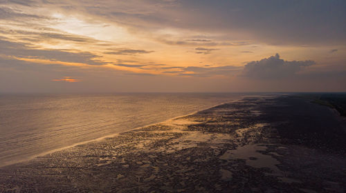 Scenic view of beach against sky during sunset