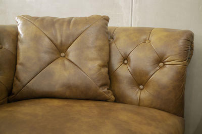 Close-up of sofa against wall at home