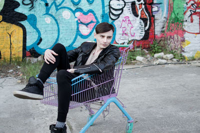 Full length of woman sitting on bench