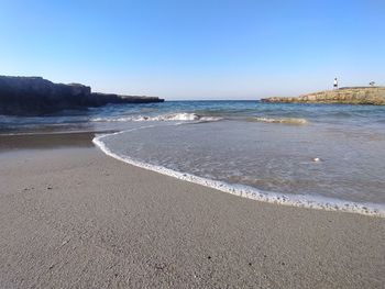 Scenic view of beach against clear sky