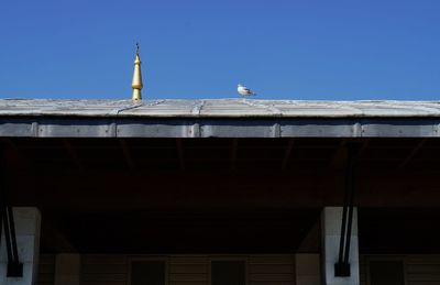 Low angle view of building against clear blue sky