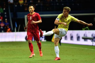 Full length of woman playing soccer ball on grass