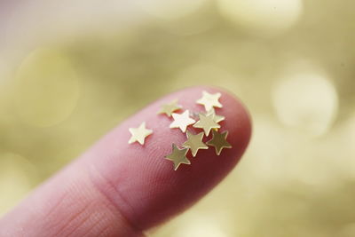 Close-up of star shape stickers on finger