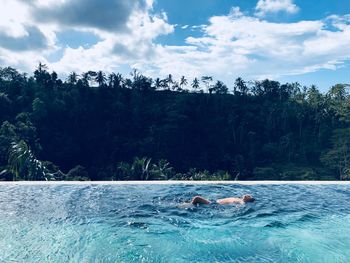 View of swimming pool in sea against sky