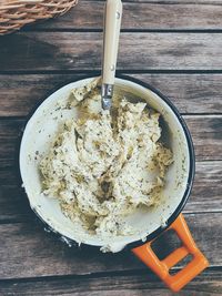 High angle view of butter with herbs on table