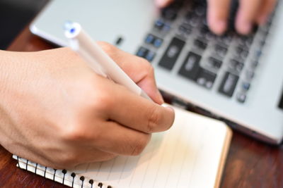 High angle view of person using smart phone on table