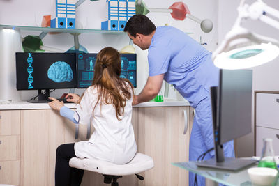 Rear view of woman working in office