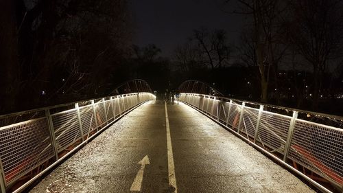 Illuminated bridge at night