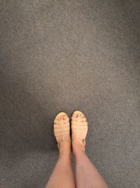 Low section of woman standing on tiled floor