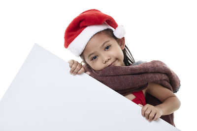 Portrait of cute girl wearing hat against white background