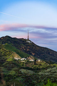 Scenic view of mountains and buildings against sky